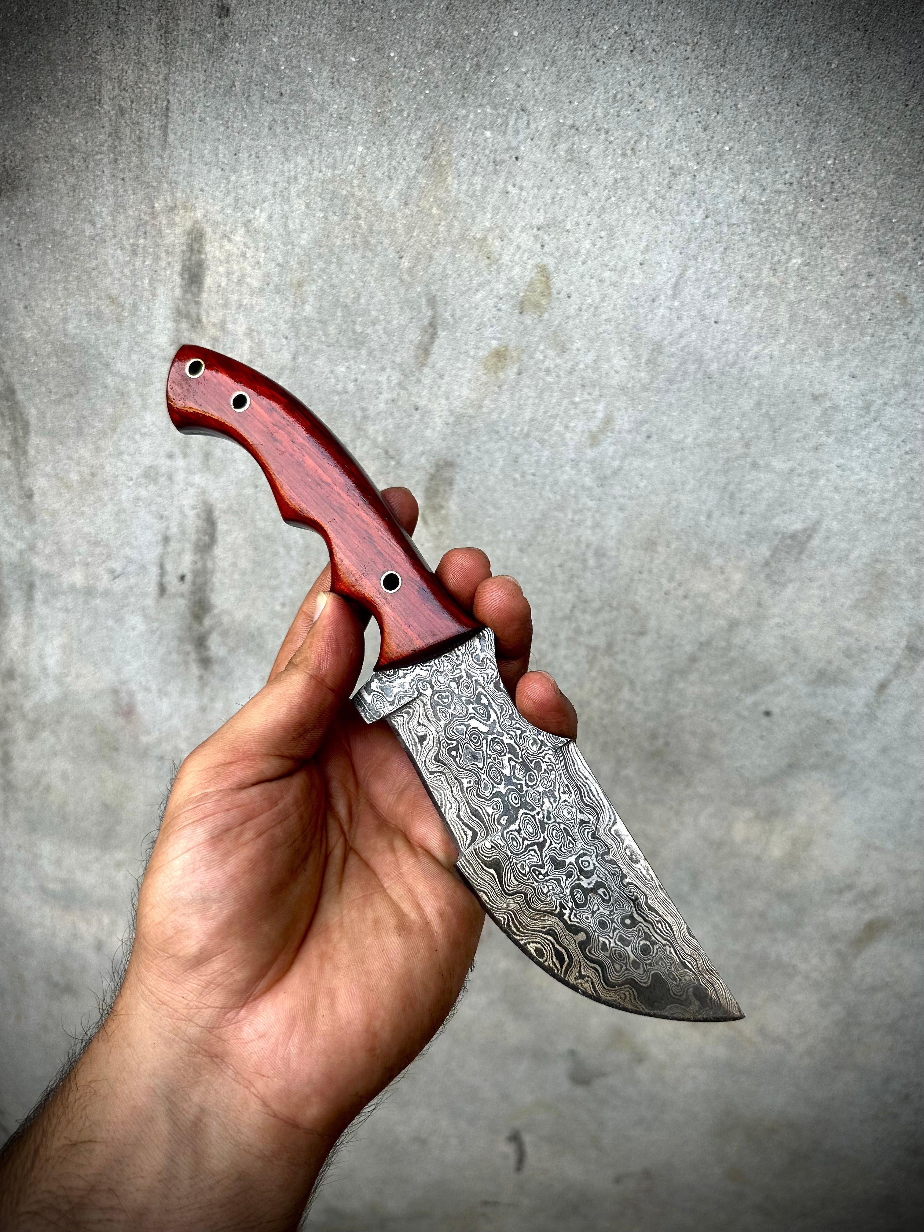 Custom Handmade Damascus Steel Tracker Knife with red Micarta Handle and leather sheath.