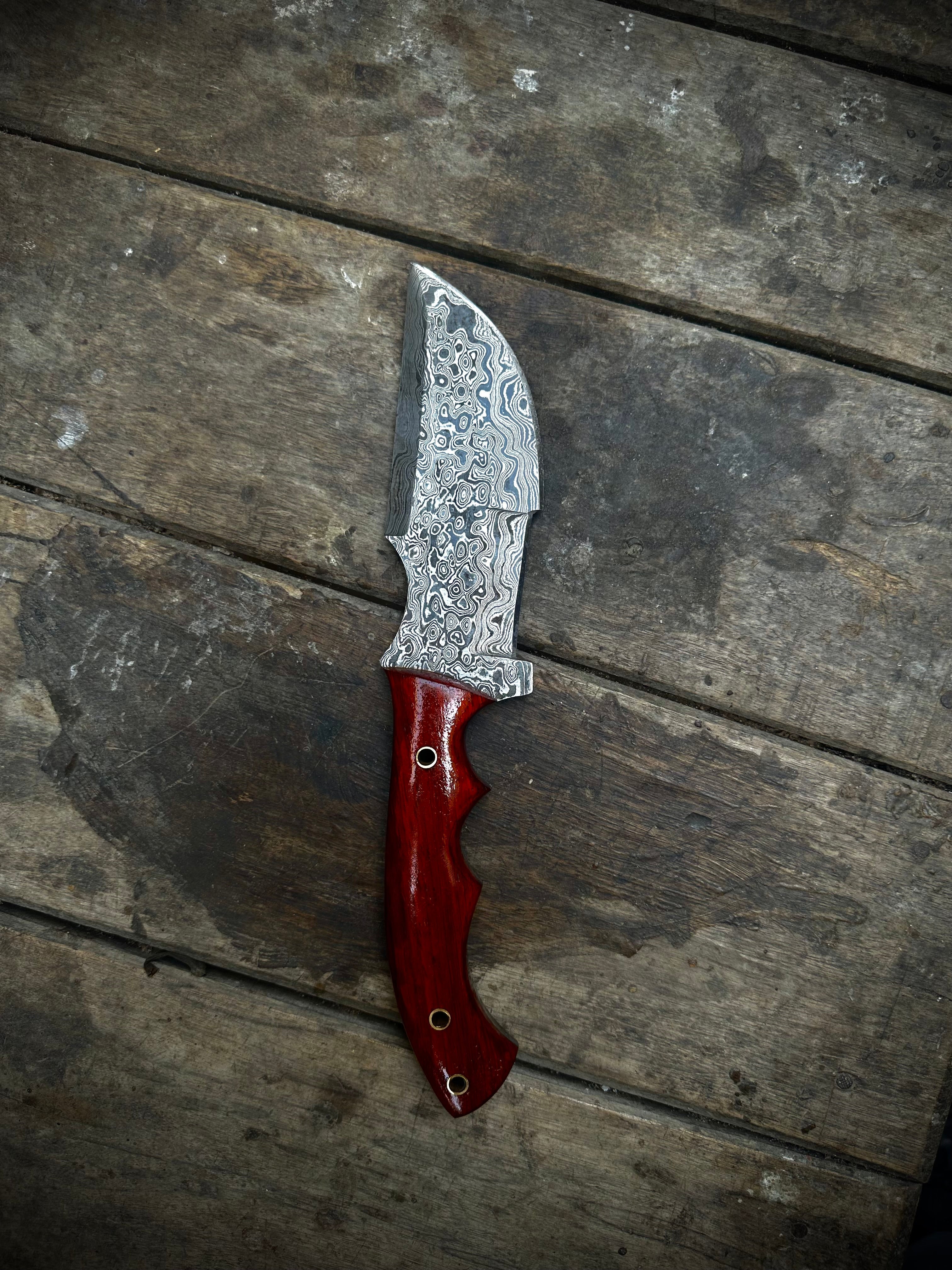 Custom Handmade Damascus Steel Tracker Knife with red Micarta Handle and leather sheath.