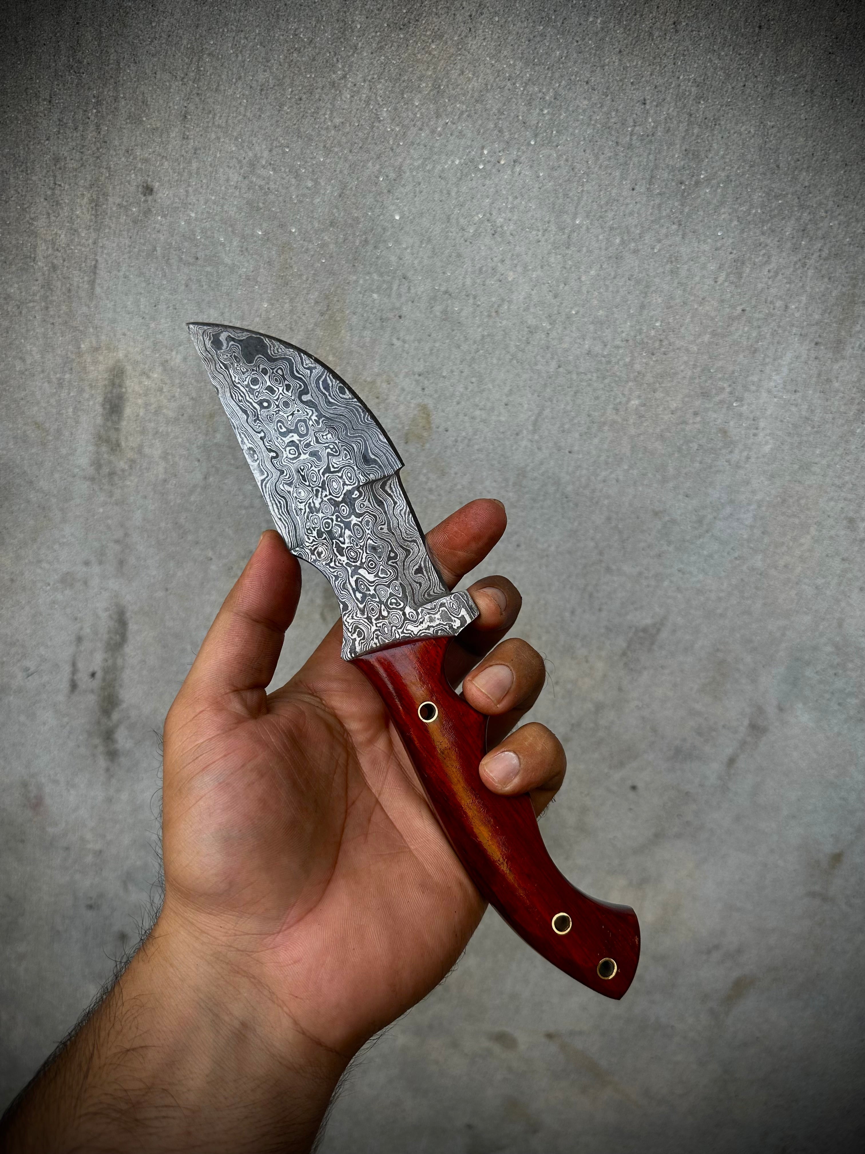 Custom Handmade Damascus Steel Tracker Knife with red Micarta Handle and leather sheath.
